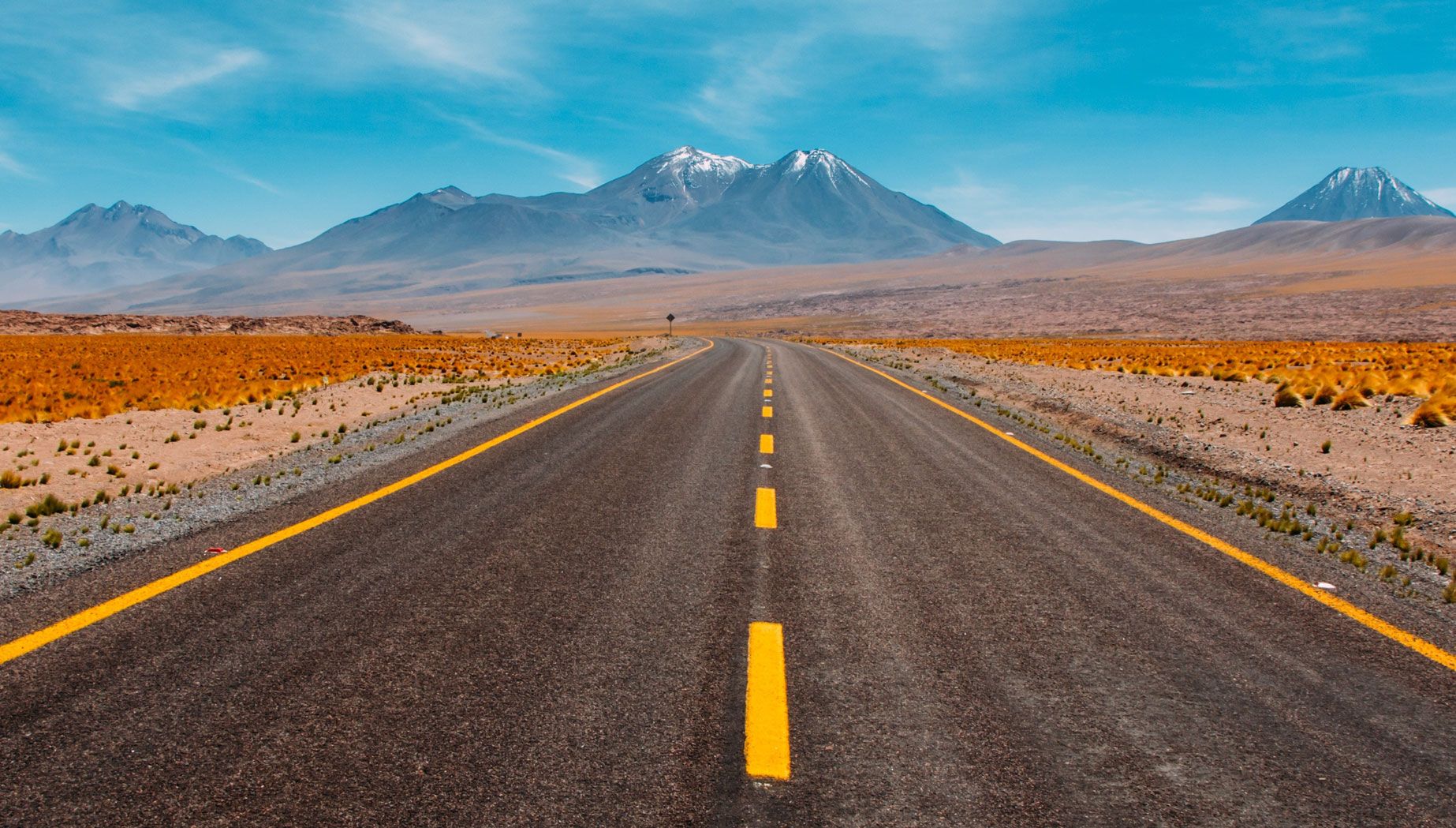 Long Open Road with Mountains in the Background Long Open Road with Mountains in the Background